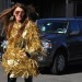 Anna Dello Rusoo wears gold fringe coat at fashion week