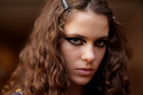 Close-up of model with bold black graphic eyeliner by Pat McGrath backstage at Louis Vuitton SS23.
