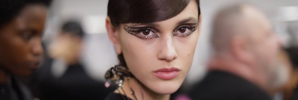 Valentino Beauty FW20 - A model with black makeup and a black dress at Valentino FW 2020